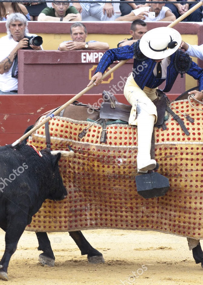 Spanish bullfight. Picador with a spear on a horse.The enraged bull attacks the bullfighter. Spain 2017 07.25.2017. Vinaros Monumental Corrida de toros. Juan Jose Padilla.